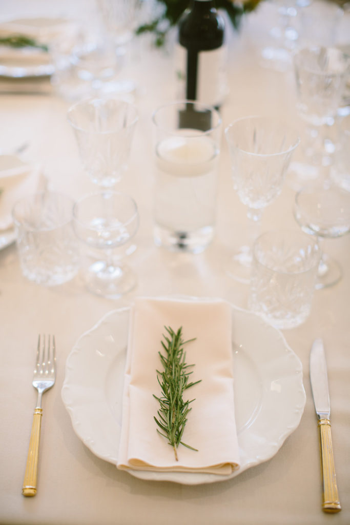 Place setting with a rosemary sprig.